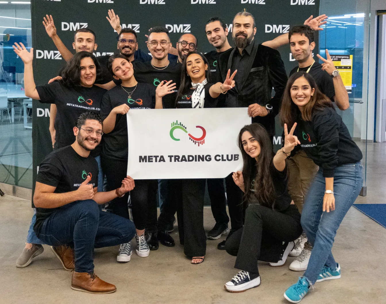 Meta Trading Club members holding the club banner at a group event in Toronto
